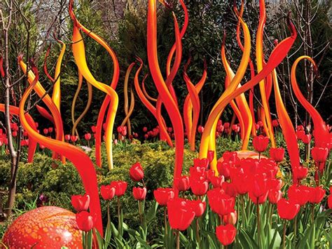 Red And Yellow Sculptures In The Middle Of A Garden