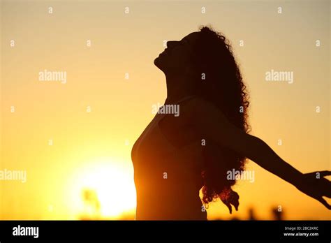 Side View Silhouette Of A Lady Breathing Deeply Fresh Air At Sunset