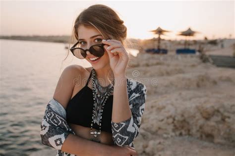 Closeup Portrait Of Attractive Young Girl Taking Off Stylish Sunglasses