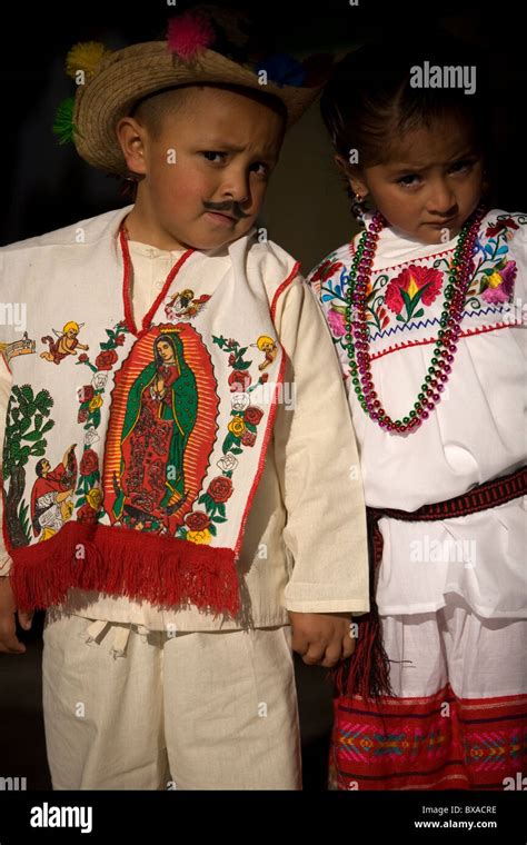 children dressing traditional indigenous costumes pose    lady