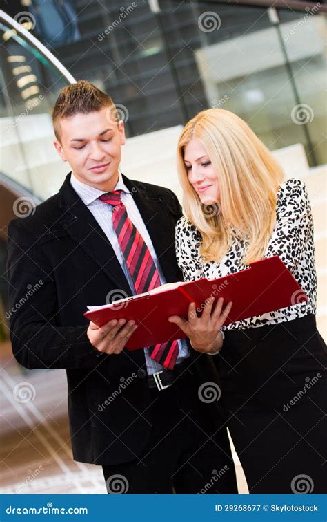 Businessman And Business Woman Talking Over Documents Stock Image