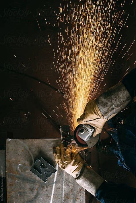 Metal Worker With Angle Grinder By Stocksy Contributor Urs Siedentop