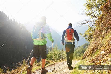 Two Men Hiking In Mountains Backpacks To Years Stock Photo