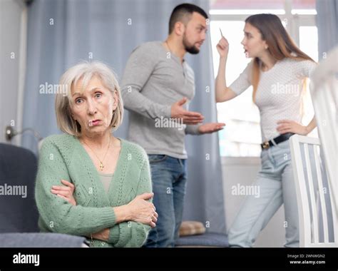 Old Woman Ignoring Her Daughter And Son In Law Arguing With Each Other