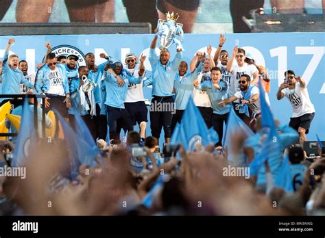 Manchester City Players Lift The Trophies On Stage During The Premier