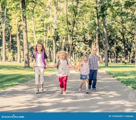 Kids Walking in the Park stock photo. Image of togetherness - 131666350