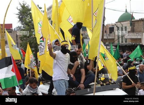 Palestinos ondean banderas de Hamás y Fateh mientras participan en una