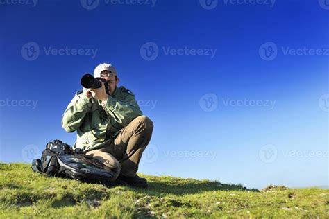 Nature photographer with digital camera 11573562 Stock Photo at Vecteezy