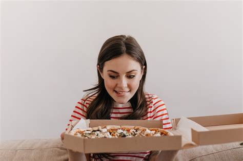 Free Photo Cute Brunette Bites Her Lip While Looking At Delicious Pizza