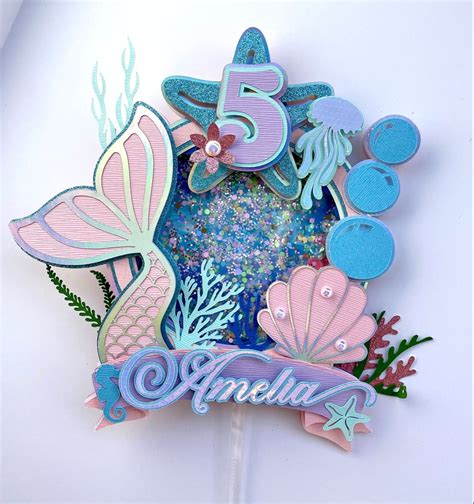 a cake topper with the number five surrounded by sea animals and ...