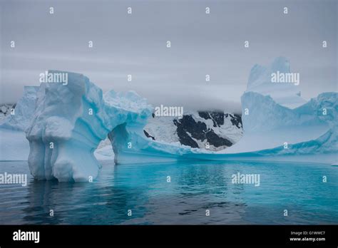 An arched iceberg melting in Antarctica Stock Photo - Alamy