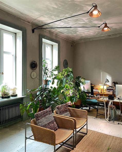 A Living Room Filled With Furniture And Lots Of Plants On Top Of