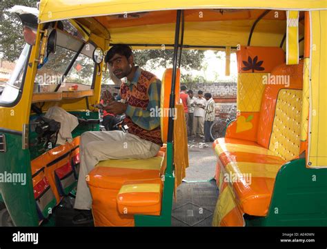 rickshaw owner sitting   newly decorated moto rickshaw agra
