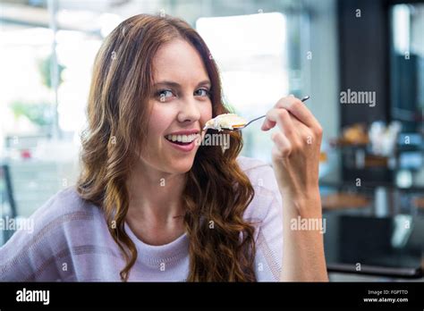 Pretty Brunette Enjoying A Cake Stock Photo Alamy
