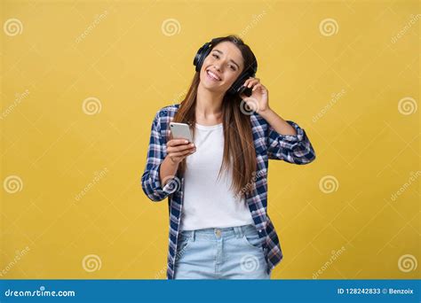 Beautiful Young Woman In Headphones Listening To Music And Dancing On