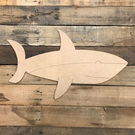 a cutout of a shark on wood planks