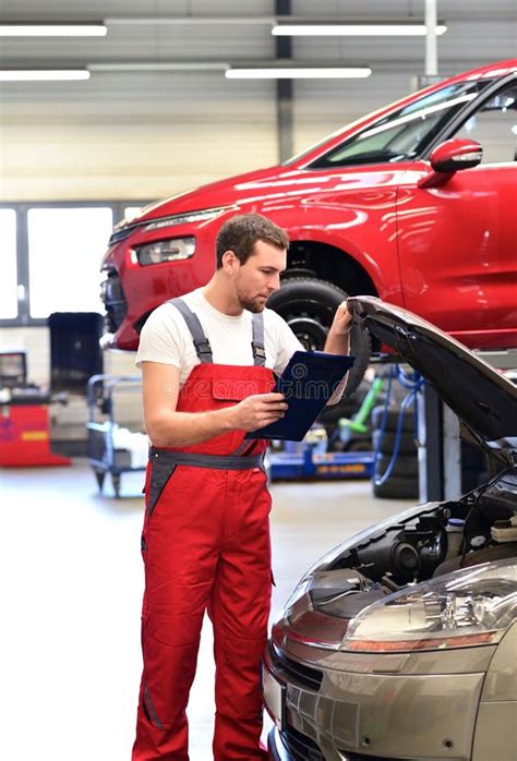 Car Mechanic in a Workshop Repairing a Vehicle Stock Photo - Image of ...