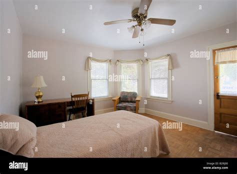 Small bedroom with a desk Stock Photo - Alamy