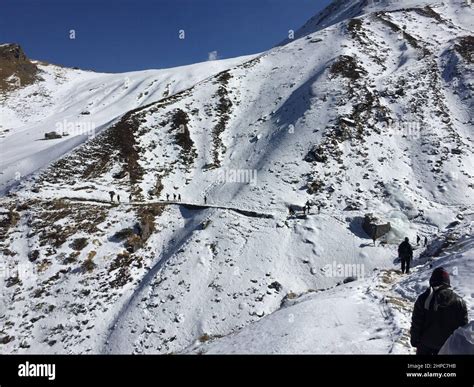 Group Of People Climbing The Snowy Mountains Stock Photo Alamy