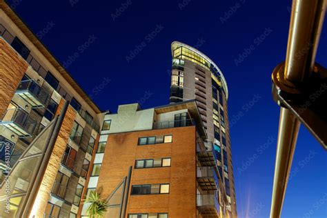 Modern high rise apartment building at night - low angle view. Stock ...