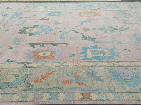 An Old Rug With Many Different Colors And Designs On It Sitting On The