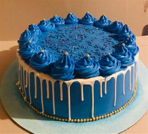 a blue cake with white icing on top