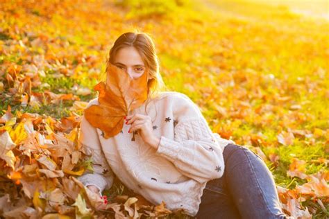 Premium Photo Young Woman With Autumn Leaves In Hand And Fall Yellow