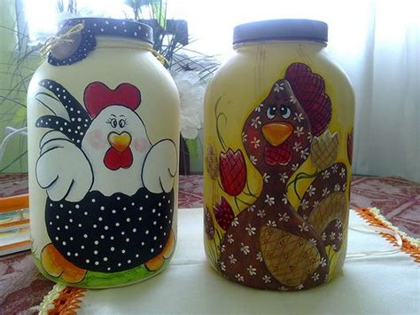 Two Painted Jars Sitting On Top Of A Table Next To Each Other With Roosters