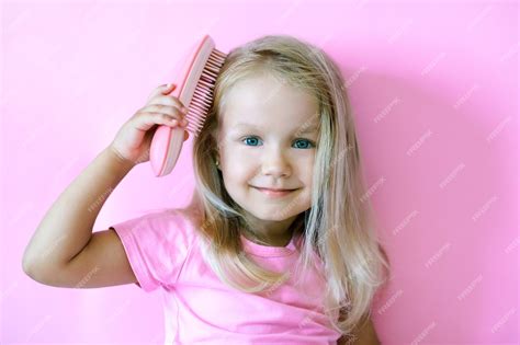 premium photo happy  girl combing  hair beauty
