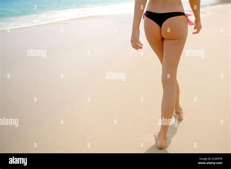 Woman Wearing Thong Bikini Walking On Beach Stock Photo Alamy