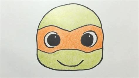 A Drawing Of An Orange And Green Ninja Mask With Eyes Drawn On It S Face