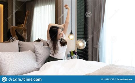 Stretch Oneself Beautiful Asian Woman Waking Up In The Morning In Her