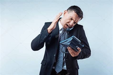 Angry mature businessman yelling at partner on phone — Stock Photo ...