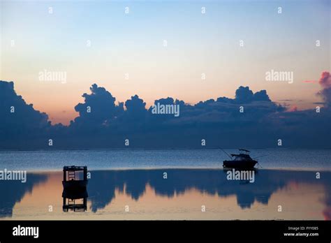 Ocean sunset, boat Stock Photo - Alamy