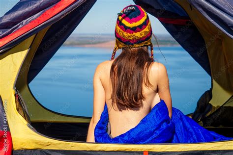 Back View Of Sexy Naked Woman Tourist In A Funny Hat From Nepal Sitting