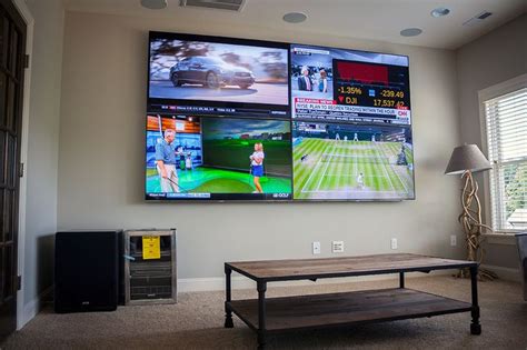 A Large Television Mounted To The Side Of A Wall Next To A Wooden