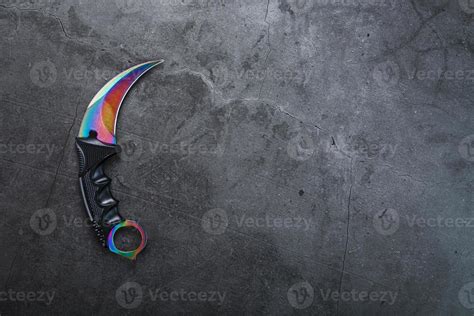 A dagger with a steel blade with a gradient color on a black background ...