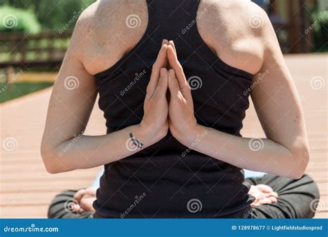 Cropped Image Of Woman Practicing Yoga In Lotus Pose And Hands In