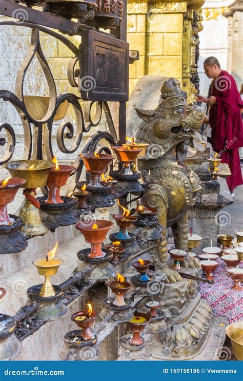 Candles and Praying Monk at the Swayambhunath Temple in Kathmandu ...