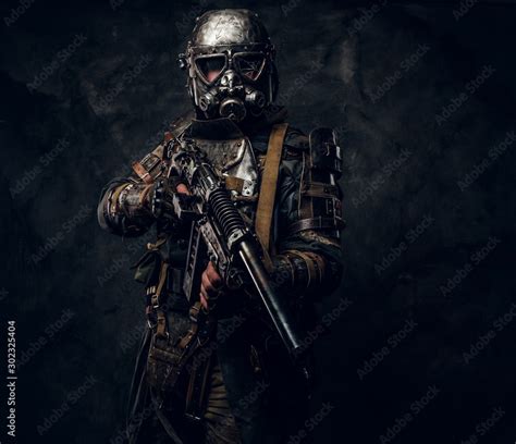 Cool cosplay costume of post - apocalypse knight, man is posing at dark ...