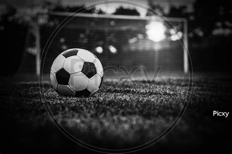 Image Of Soccer Sunset Football On The Green Field In Soccer Stadium