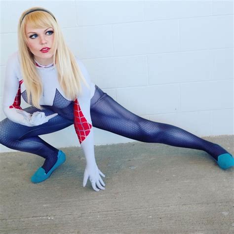 A Woman Dressed As Spider Man Poses On The Floor With Her Legs Spread Out