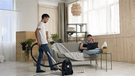 Handsome Gay Man Dancing And Cleanup With Helping Of The Vacuum Cleaner While His Partner