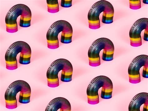 Premium Photo Colorful Retro Toys Slinky Pattern Over Pink Background