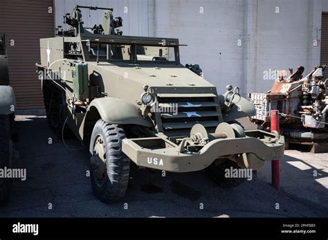 A military utility vehicle is parked alongside two other vehicles in an ...