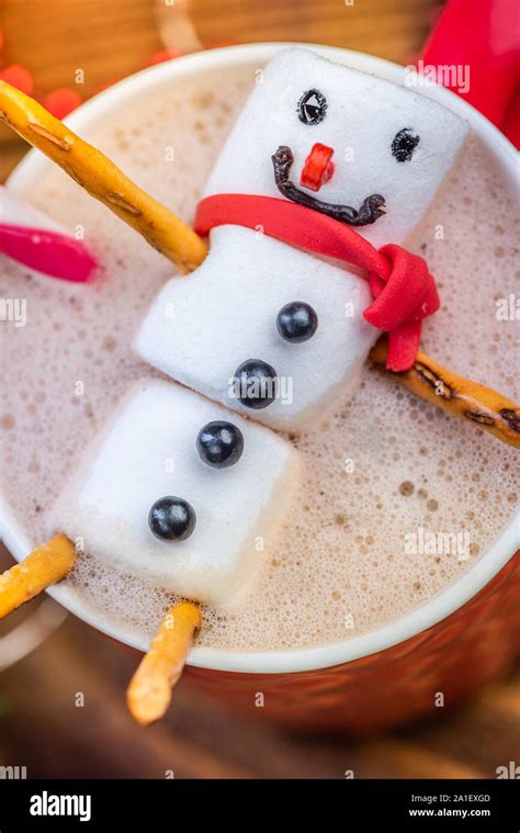 Marshmallow Snowman Melting In Hot Chocolate In Red Festive Cup Stock Photo Alamy