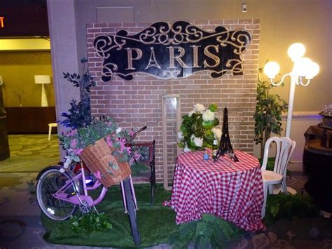 Paris Themed Corporate Holiday Party Cafe Set Up With Bistro Tables And Floral Arrangements