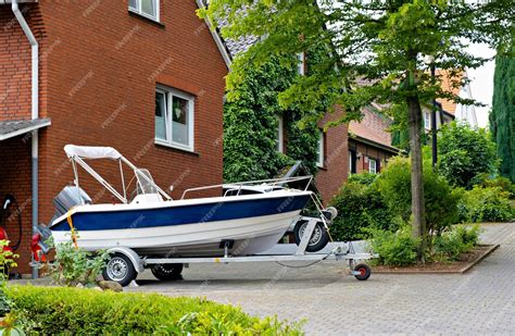 Premium Photo Blue And White Boat Parked In Front Of Red Brick