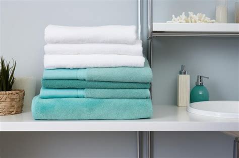 Premium Ai Image Folded Fluffy Towels On A Clean Bathroom Shelf