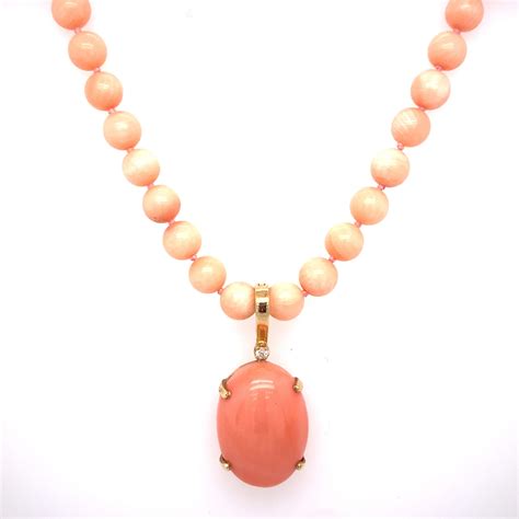 Circa 1980s Pink Coral Beaded Necklace With Oval Enhancer In 18k Gold